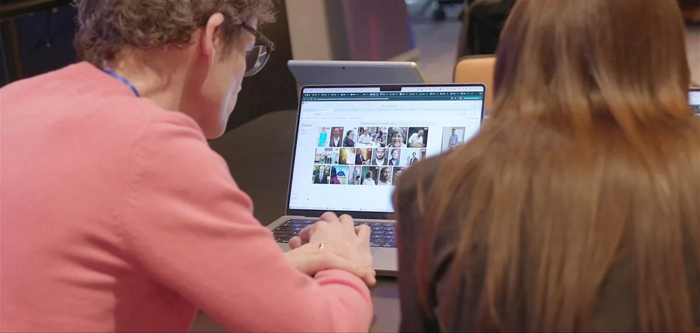 Participants working at a laptop during the deepfake hackathon