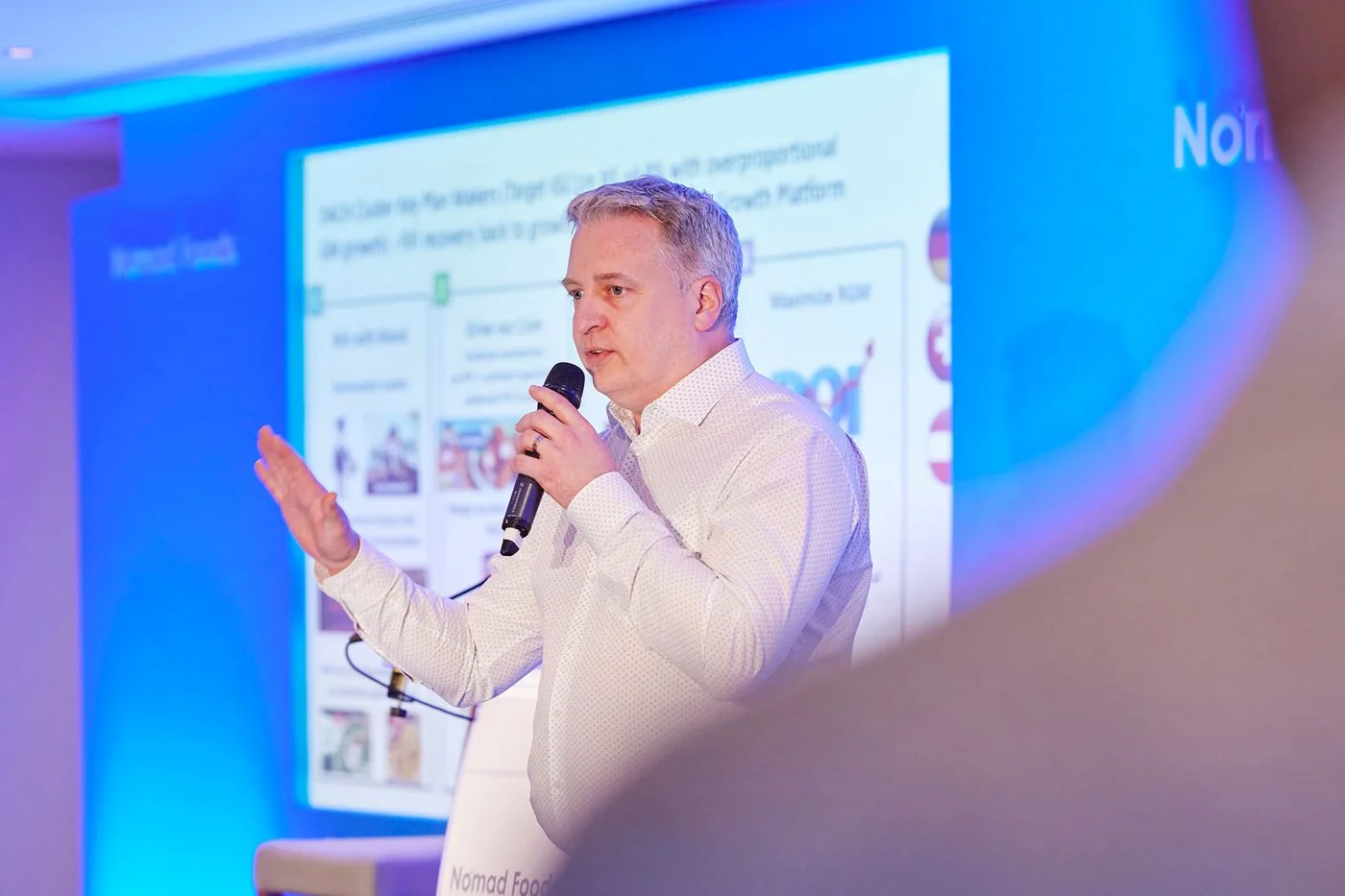 A speaker presenting during the Nomad Foods conference